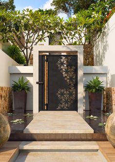 a modern entry way with steps leading up to the door and potted plants on either side