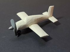 a small toy airplane sitting on top of a table