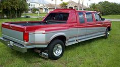 a red pick up truck parked in the grass