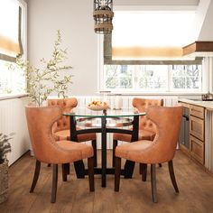 a dining room table with four chairs around it