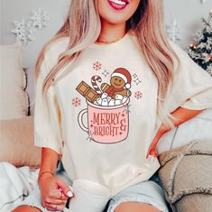 Merry and Bright Shirt! Cute Christmas Tee, Gingerbread Shirt,  Holiday Shirts, Christmas Party Tee, Ladies Holiday Shirt. A must have for the holidays!   Super cute Holiday design on  Comfort Colors T-shirts.  Available in White, Ivory or Pepper.  Order a size up for a oversized fit. Vintage style print Printing process is Direct to Garment aka DTG. All shirt are made to order. Please double check sizing before placing your order. Shirt Brand. Comfort Colors 100% Ring spun Cotton. Classic fit. Unisex sizing, so it fits more loose than women sizing. Sizes: S, M, L, XL, 2XL, 3XL & 4XL. Size chart is in photos for reference. Care Instructions. Wash inside out on a gentle cycle in cold water.  Hang to dry or tumble dry on a low heat setting. DO NOT Dry Clean or use bleach. Shipping. We offer Christmas Pregnancy Announcement Shirt, Baby Reveal Shirt, Womens Christmas Shirts, Happy Hippie, Retro Holiday, Hippie Shirt, Christmas Tree Shirt, Pregnancy Announcement Shirt, Maternity Tees