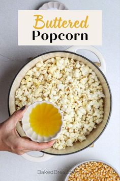 a person is dipping butter on popcorn in a pot with other ingredients around it and the words buttered popcorn above them