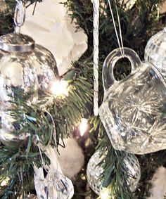 some glass ornaments hanging from a christmas tree