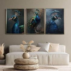 three paintings of peacocks on a wall in a living room