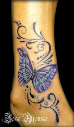 a purple butterfly tattoo on the foot