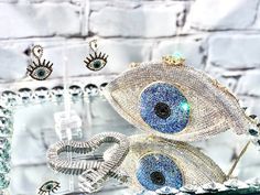 Gorgeous Rhinestone women’s clutch ! the perfect statement accessory  to sparkle your outfit.THIS IS NOT SOLD AS A SET Chocker and earrings available on a separate listing.🧿4.5”H X 7.5”W 🧿Chain 19”Follow us in Instagram: @kyboutique4SHARE YOUR PICTURES IN INSTAGRAM #kyboutique4Website: Visit un also on the webwww.kyboutique4.comPlease make sure to read my Shipping Terms & Conditions Information prior to making a purchase:https://www.etsy.com/shop/Kyboutique4/policy Evil Eye Bag, Gold Star Earrings, Marble Earrings, Moon And Star Earrings, Rhinestone Clutch, Crystal Clutch, Party Clutch, Ladies Clutch, Triangle Earrings