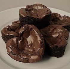 three chocolate brownies on a white plate