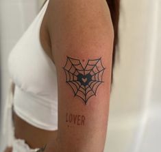 a woman's arm with a spider web tattoo on it and the word lover written in black ink