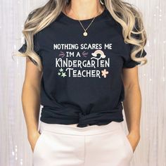 a woman wearing a t - shirt that says nothing scaries me i'm a kindergarten teacher