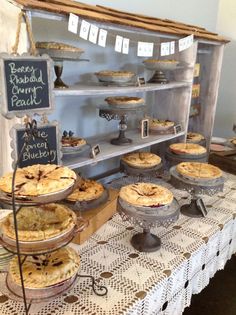 several pies are on display at a bakery