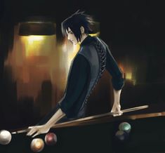 a man standing on top of a pool table next to a pool ball racket