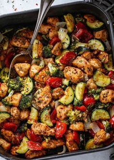 a casserole dish with chicken, broccoli, and red bell peppers