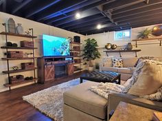 a living room filled with furniture and a flat screen tv mounted on a wall above a fireplace