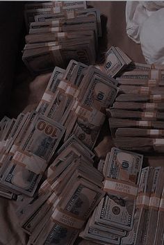 a pile of money sitting on top of a bed