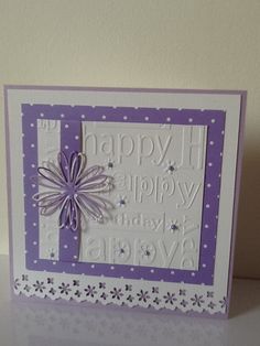 a purple and white greeting card with a flower on the front that says happy birthday