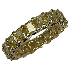 18K yellow gold eternity Band featuring radiant-cut yellow diamonds with a high polish finish. Totalling 19 pieces of brillant cut radiant diamonds, weighing 6.339 carats, the width is 4mm. Ring size only can sizing down to US#5, cannot sizing it up. Gia Certified Rectangular Yellow Gold Diamond Ring, Gold Square Cut Gia Certified Ring, Gia Certified Square Cut Gold Ring, Gia Certified Rectangular Gold Diamond Ring, Yellow Gold Emerald Cut Diamond Eternity Band, Yellow Diamond Ring With Baguette Cut, Yellow Diamond Baguette Cut Ring, Gold Emerald Cut Diamond Eternity Band, Gold Emerald Cut Eternity Band For Formal Occasions