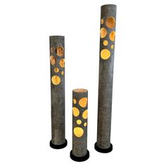 three tall metal poles with yellow dots on them