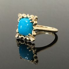 "14K Yellow Gold Turquoise and Diamond Ring METAL: 14K Yellow Gold TOTAL WEIGHT: 7.5 g TURQUOISE: Cushion Cabochon AAA Sleeping Beauty Turquoise Mined in Arizona 10 mm x 10 mm DIAMONDS: 4 Round Brilliant Cut Diamonds COLOR: H CLARITY: VS2 TOTAL WEIGHT: 0.04 SIZE: Ladies size 4-12. Please indicate your ring size at checkout. DESCRIPTION: This original design features an 10mm x 10mm Sleeping Beauty Turquoise. It has a sunburst design surrounding it, with a diamond set in each corner of the \"halo\ 14k Yellow Gold Turquoise Cabochon Ring, 14k Gold Turquoise Cabochon Ring, Fine Jewelry Turquoise Cabochon Ring In 14k Gold, Turquoise Opal Ring Fine Jewelry, Fine Jewelry 14k Gold Turquoise Cabochon Ring, Heirloom Yellow Gold Turquoise Cabochon Ring, Fine Jewelry Blue Turquoise Cabochon Ring, Elegant Turquoise Opal Ring With Gemstone, Elegant Turquoise Opal Gemstone Ring