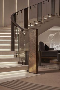 an elegant staircase with glass railing and handrail