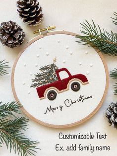 a christmas ornament with a red truck and pine cones