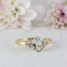 Delightful vintage inspired White sapphire ring.Bezel set with an 8x6 mm Oval cut White sapphire with a slight bluish tint.Could be a great alternative engagement ring or a unique everyday ring.Shown in photos in 14K Yellow gold size 6.5Made in all rings sizes, and in in 10K, 14K and 18K Gold.Handmade by an artist in solid gold with an utmost attention to details.Beautifully finished with Each gemstone handpicked and inspected for the best color and depth.`Get this ring today and enjoy it foreve Elegant Topaz Ring With Rose Cut Diamonds For Promise, Delicate Formal Rings With Accent Stones, Elegant Topaz Ring With Rose Cut Diamonds, Elegant Oval Birthstone Ring With Rose Cut Diamonds, Elegant Birthstone Ring With Rose Cut Diamonds, Art Deco Oval Topaz Ring For Wedding, Gold Ring Engagement, Green Stone Rings, White Sapphire Ring