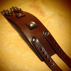 "This Brown leather cuff is2.25\" wide cuff is custom hand dyed in a rich brown finish . It features two 3/4\" watch connectors and uses two 5/8\" straps. Two top quality stainless steel buckles and hand polished rivets provide the closure A great width for any wrist! This cuff is inspired by the early Johnny Depp cuffs. can be used with or without a watch! I'll need your wrist size for this cuff! Please use the instructions in the pics above! Thanks for checking out my work! I use a fine hand i Brown Leather Strap Cuff Bracelet, Adjustable Brown Jewelry With Antique Buckle, Vintage Cuff Bracelets With Wrist Strap, Vintage Cuff Bracelet With Wrist Strap, Vintage Leather Cuff Bracelet With Wrist Strap, Vintage Brown Leather Strap Wristband, Vintage Brown Cuff Bracelet With Wrist Strap, Vintage Brown Bracelet With Strap, Vintage Brown Bracelets With Bracelet Strap