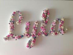 the letters are made out of flowers and each letter has an individual name on it