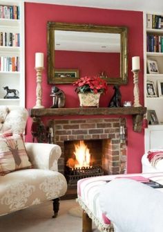 a living room filled with furniture and a fire place in front of a book shelf