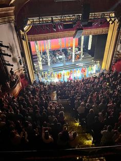 an auditorium full of people and stage lights