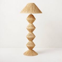 a lamp made out of bamboo sticks on a white background