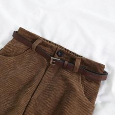 Crafted in corduroy, these dark academia pants in brown or black offer a vintage vibe with a modern spin. The high waist, secured with an elasticated band, pairs with a wide-leg style. Four classic pockets and a complementary belt complete the look. Dark academia aesthetic Elasticated waist Cotton, polyester Corduroy material High waist Classic 4 pockets Wide leg Belt included Dark Academia Pants, Preppy Aesthetic Outfits, Jeans Patchwork, Dark Academia Clothing, Brown Streetwear, Corduroy Pants Women, Pants Korean, Cords Pants, Leg Belt