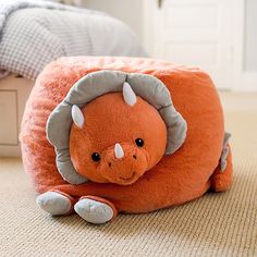 an orange stuffed animal laying on the floor