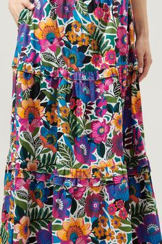 A little artsy floral action never hurt anyone. Complementary flower motifs work together to create the Santa Elena print. It decorates a tiered maxi skirt with ruffle trim. An elastic waist tops a flowy fit with side pockets. Wear it with a solid tank and sandals for an effortless, boho look.- Elastic waist- Pockets- Ruffle trim- Flowy fit- Color: Floral MultiSize + Fit - Model is 5'9" and wearing size S- Measurements taken from size S - Waist: 13 3/4"- Length: 38" Fabric Self: 100% Cotton Styl Flowy Ruffled Maxi Skirt For Garden Party, Garden Party Ruffled Maxi Skirt, Spring Floral Print Tiered Maxi Skirt, Spring Multicolor Maxi Skirt With Voluminous Fit, Tiered Multicolor Floral Print Maxi Dress, Flowy Tiered Maxi Skirt With Floral Patchwork, Floral Print Tiered Maxi Dress For Garden Party, Casual Tiered Maxi Skirt With Floral Print, Casual Multicolor Tiered Maxi Dress