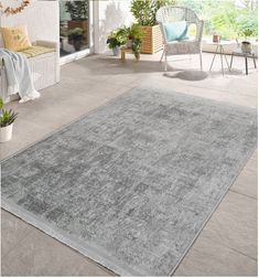 a large gray rug sitting on top of a patio