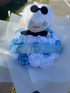 a teddy bear sitting on top of a bouquet of flowers with a ribbon around it that says daddy's home