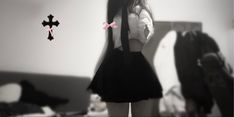 a girl standing in front of a mirror with her back to the camera