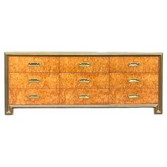 an old dresser with many drawers and brass pulls on it's sides, against a white background