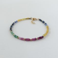 Introducing this stunning rainbow Ruby, Emerald, Blue and Yellow Sapphire mixed bracelet, featuring dainty, skinny minimalist design.  This  2.5mm gemstone beaded bracelet will make an ideal gift for women. Ruby is July Birthstone, Emerald is May Birthstone and Sapphire is September Birthstone, making it an ideal  jewelry gift for a mother, friend, girlfriend, daughter, sister, teacher, wife, bride, bridesmaid, or yourself. It is perfect for stacking or layering all year around. It is timeless and classy and made to last. It will come in a gift-ready pouch. Perfect engagement, wedding, birthday, or anniversary gift. -2.5mm mix of different shades of Emerald, Ruby, and Sapphires (Yellow and blue). Note that the bracelet appears larger in photos due to its close-up view -Choice of sterling s Rainbow Ruby, September Gift, Bracelet Emerald, Emerald Blue, Friend Girlfriend, Multi Sapphire, Jewelry Minimalist, Earring Ideas, Rainbow Bracelet