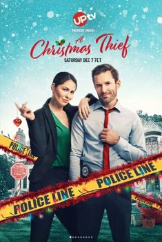 a man and woman standing next to each other in front of a christmas themed poster