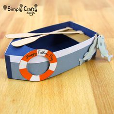 a cardboard box with an orange and white life preserver on it sitting on a wooden table