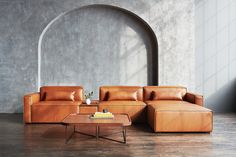 a living room with two couches, a coffee table and an arch in the wall