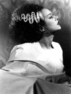 a black and white photo of a woman with curly hair