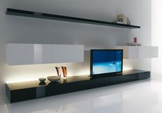 a flat screen tv sitting on top of a black entertainment center in a living room