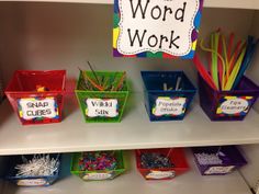 the word work display is organized with plastic containers and pencils in each bin, along with other writing materials