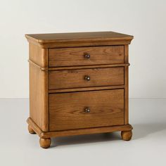 a wooden nightstand with two drawers on it