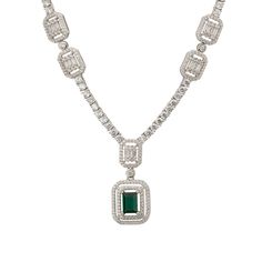 Elevate your elegance with the Evita Emerald Statement Necklace in Silver. This exquisite piece redefines luxury with its tennis necklace design. The centrepiece is a breath-taking pendant drop, featuring two distinct rectangular settings. The larger setting cradles a stunning lab-grown emerald, enveloped by two dazzling rows of zircons. This masterpiece gracefully connects to a smaller rectangular setting, where baguette-cut zircons are framed by a single row of glistening zircons.  Adding to i Elegant Baguette Cut Emerald Necklace For Formal Events, Elegant Baguette Cut Emerald Necklace For Formal Occasions, Elegant Gemstone Tennis Necklace For Anniversary, Luxury Rectangular Diamond Necklace, Luxury Rectangular Pendant Necklace For Wedding, Elegant Rectangular Necklaces For Formal Occasions, Elegant Formal Rectangular Necklace, Elegant Jewelry With Baguette Diamonds In Rectangular Shape, Elegant Rectangular Emerald Necklace For Formal Occasions