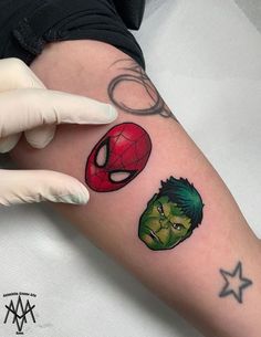 a woman's arm with tattoos on it, including the hulk and spider - man