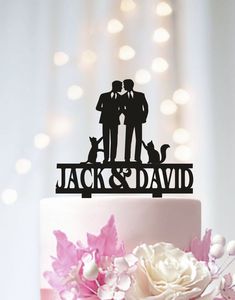 a wedding cake topper with two people and a dog