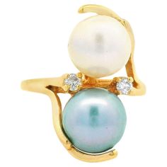 –Stone(s)– (2) Natural Genuine Diamonds - Round Brilliant Cut - Prong Set - G Color  - SI1 Clarity - 0.40ctw (approx.) (1) Genuine Cultured Pearl - Round Shape- Gray Color w/ Blue Overtone  - 7.46mm (approx.) (1) Genuine Cultured Pearl - Round Shape- White Color w/ Nice Luster  - 7.26mm (approx.) Material: Solid 14k Yellow Gold Weight: 3.11 Grams Ring Size: 3.0 ( fitted on finger, please contact us prior to purchase with sizing inquiries) Ring Width: 18.14mm (0.71") (top of the ring - north to south) - 1.4mm (bottom of the shank) Ring Height: 9.36mm (rise off finger) Condition: Vintage, light wear. Original finish & patina intact. Excellent condition! Stock Number: JO-17013060-05202411 Pearl And Diamond Ring, Gold Cocktail Ring, Shopping Photography, Cartier Love, Auction Items, Tahitian Pearls, Pearl Diamond, Love Ring, Gold Jewelry Fashion