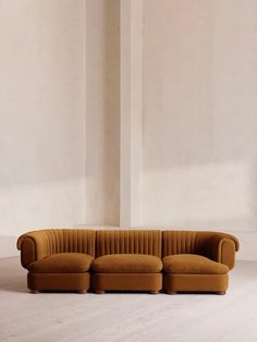 a brown couch sitting on top of a white floor